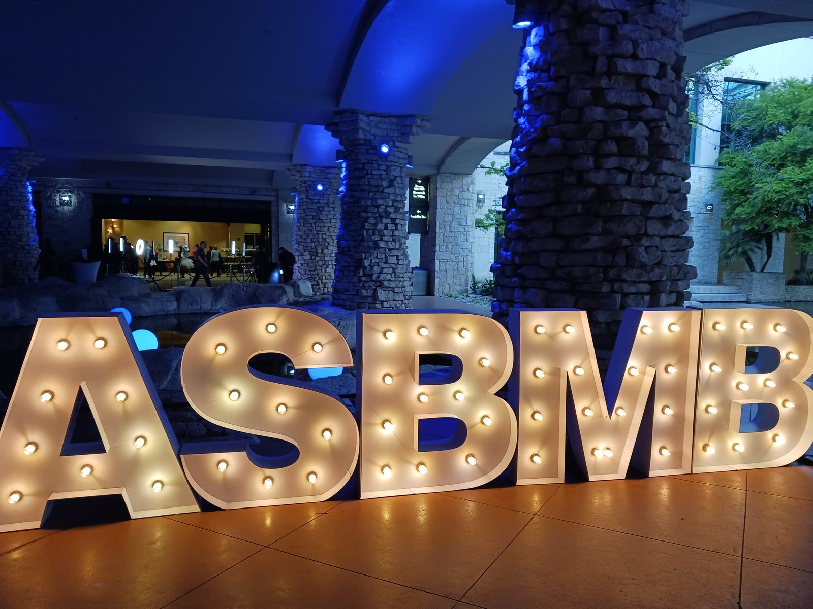 Illuminated ASBMB marquee letters at night