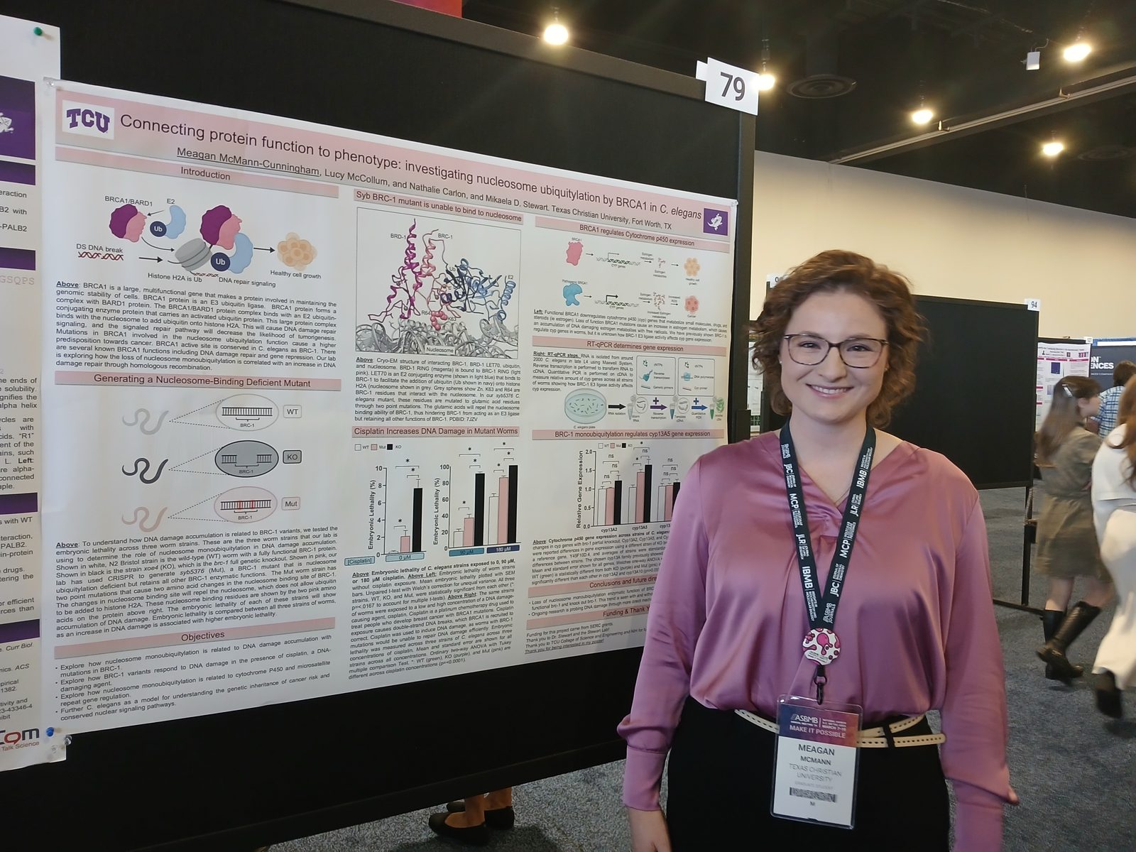 Student at the ASBMB national meeting beside a research poster