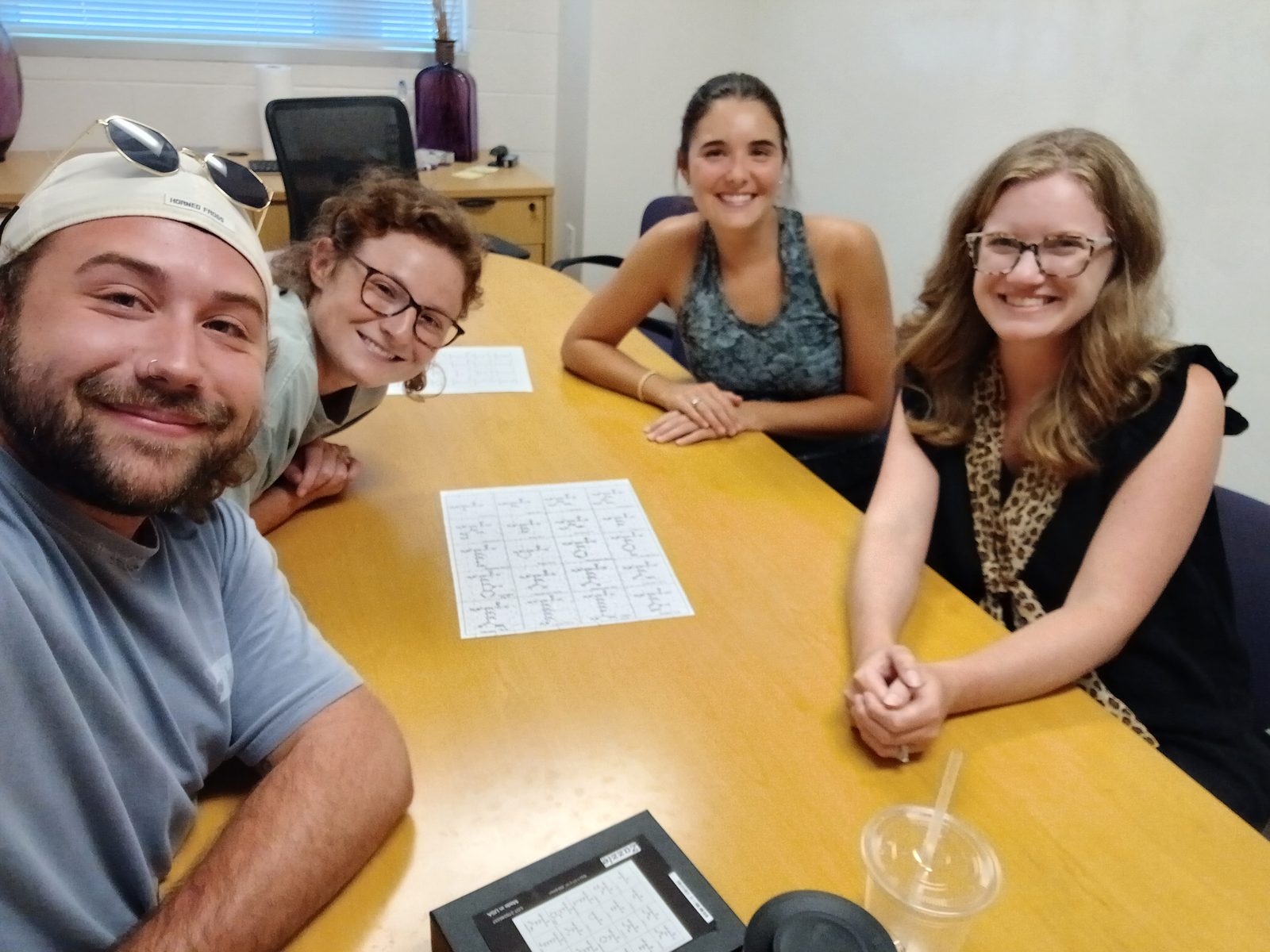 Four lab members gathered around a table