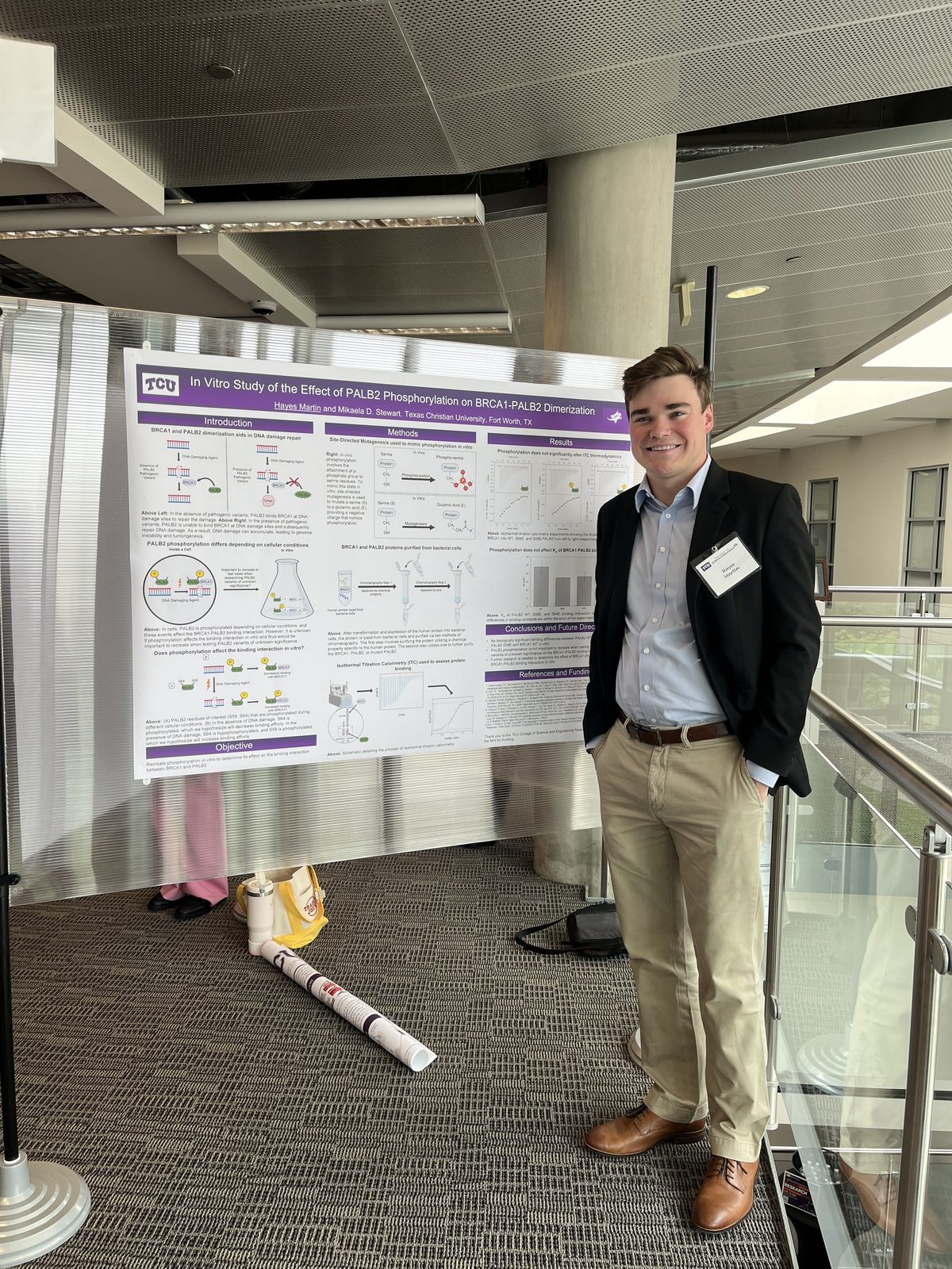 A student beside a poster on BRCA1-PALB2 dimerization