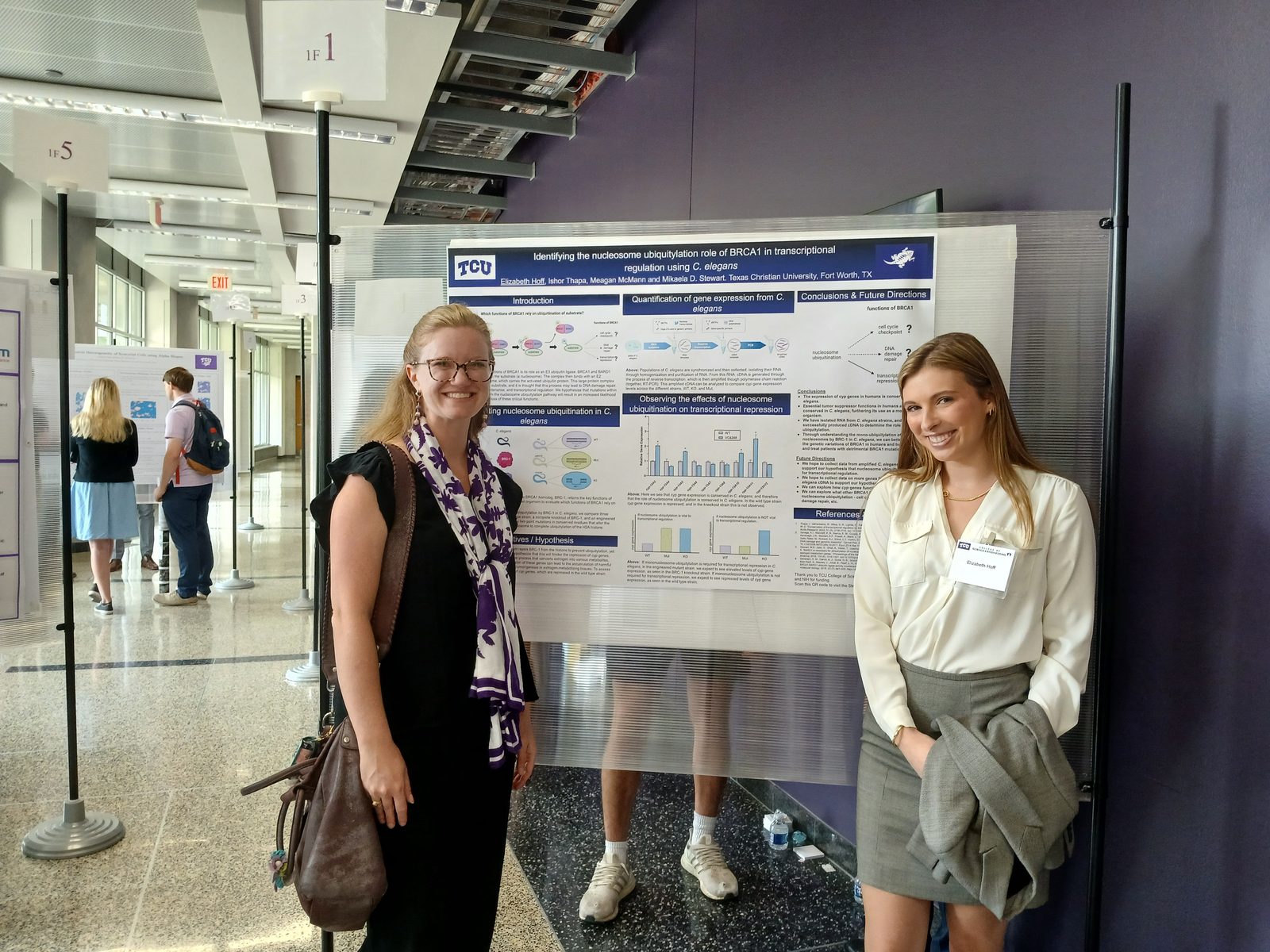 Dr. Stewart and a student beside a C. elegans BRCA1 poster